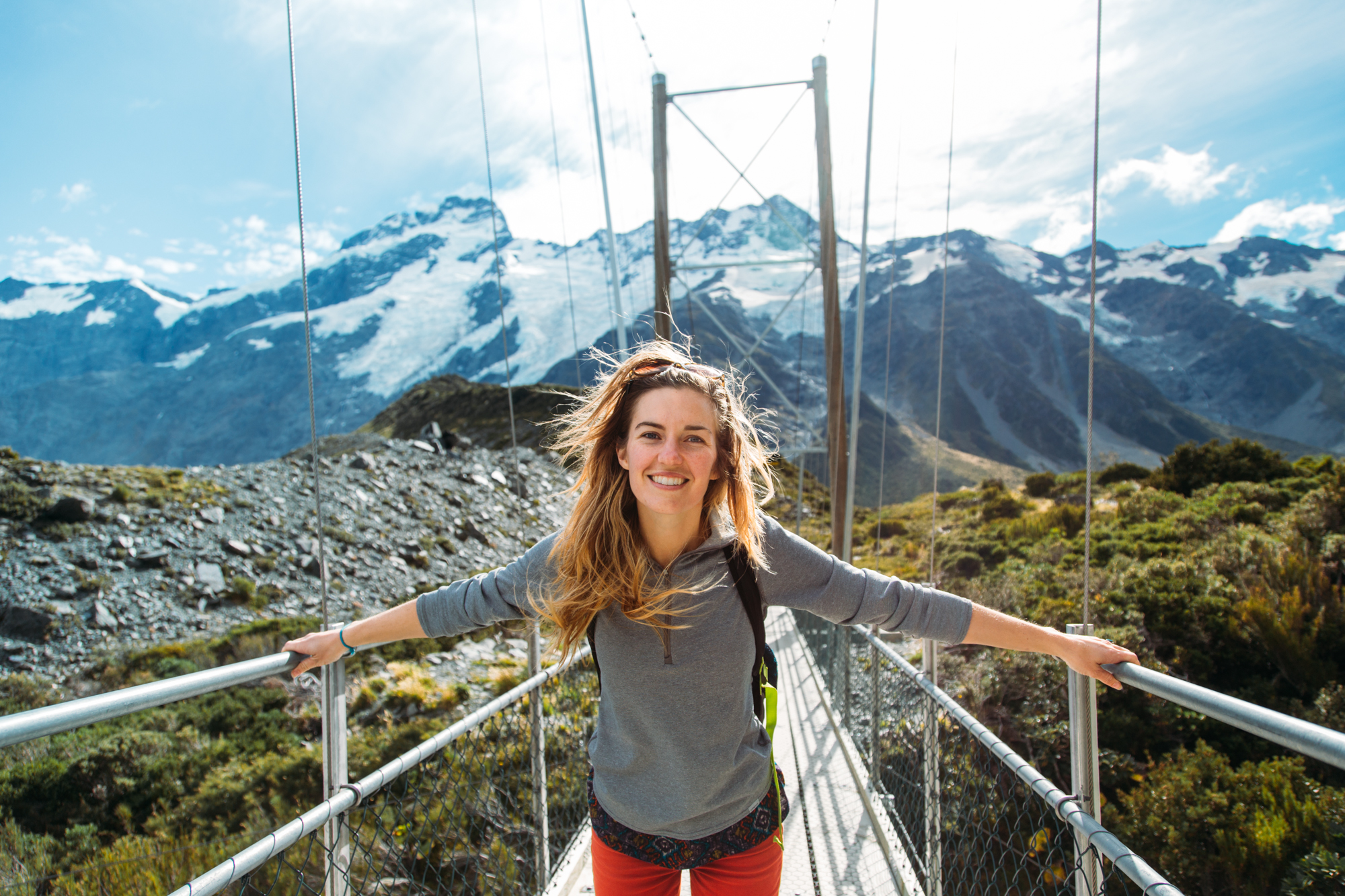 Girl on swing bridge New Zealand