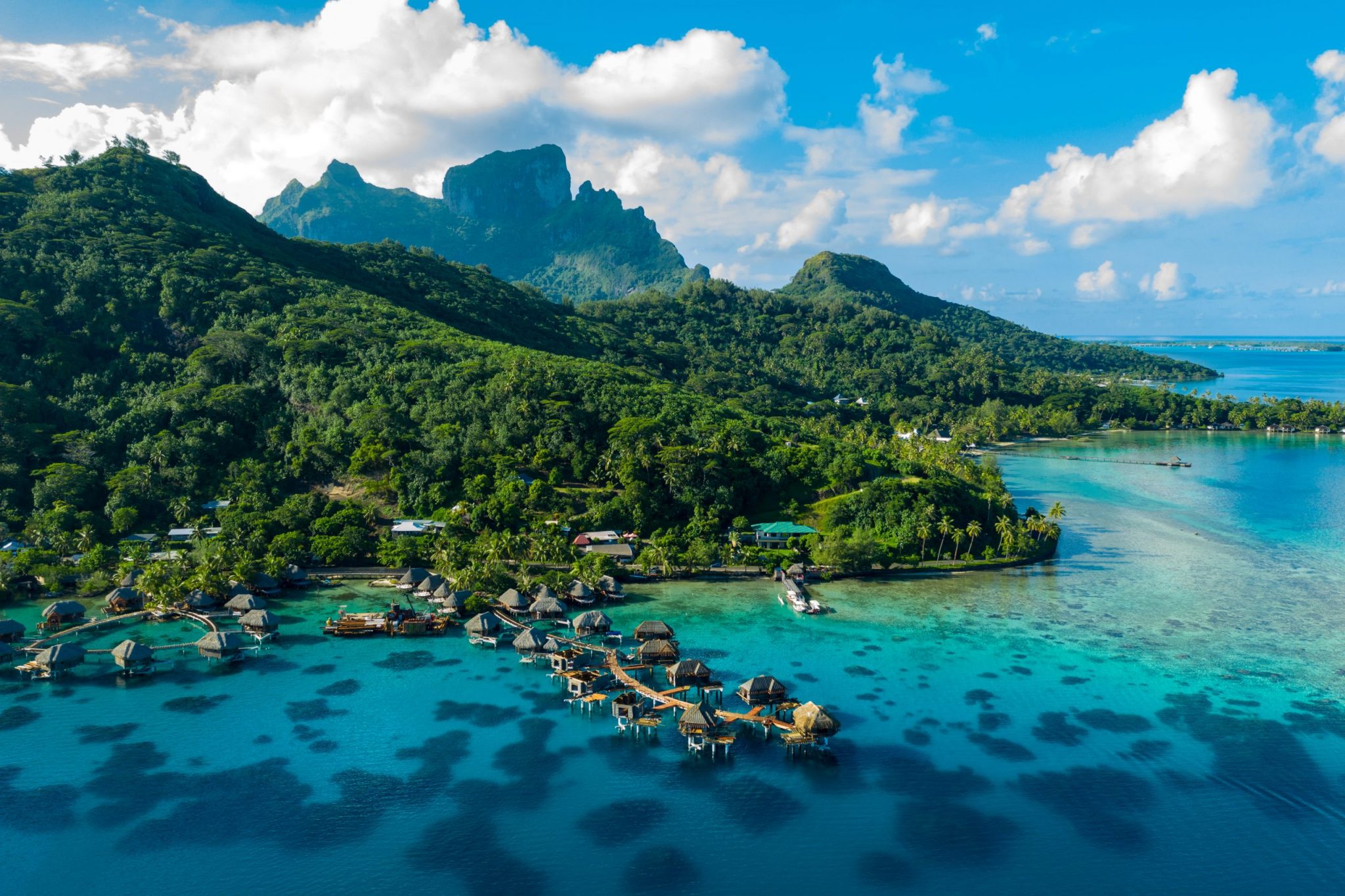 Bora Bora aerial drone image of travel vacation paradise and overwater bungalows