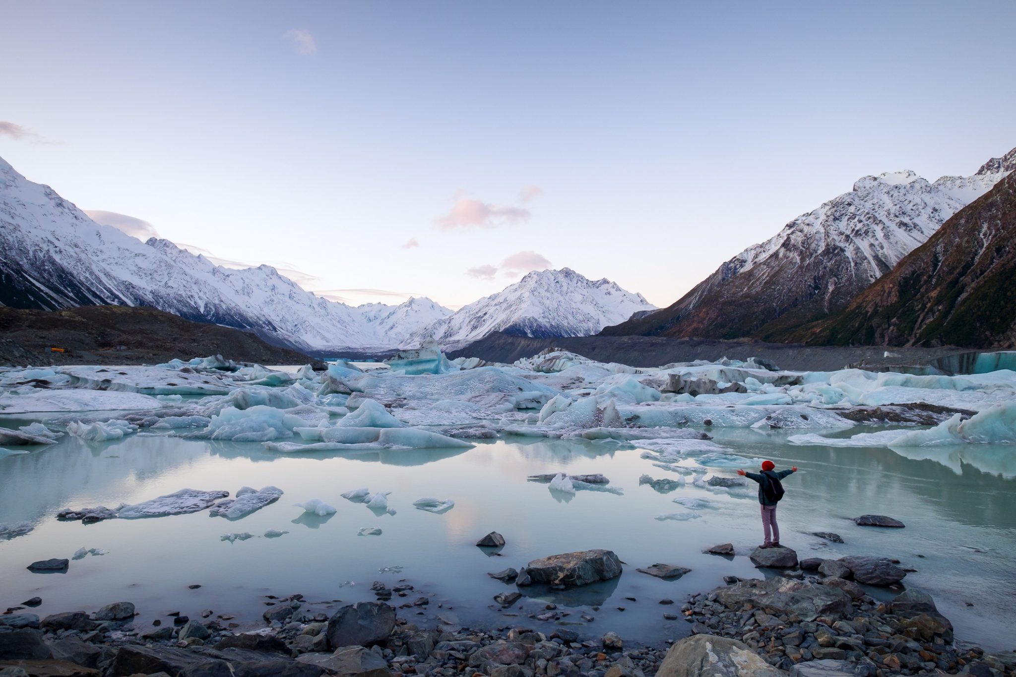 Traveler viewing icebergs landscape and snow mountains in New Zealand